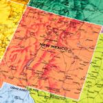 Red map of the state of New Mexico with cities 